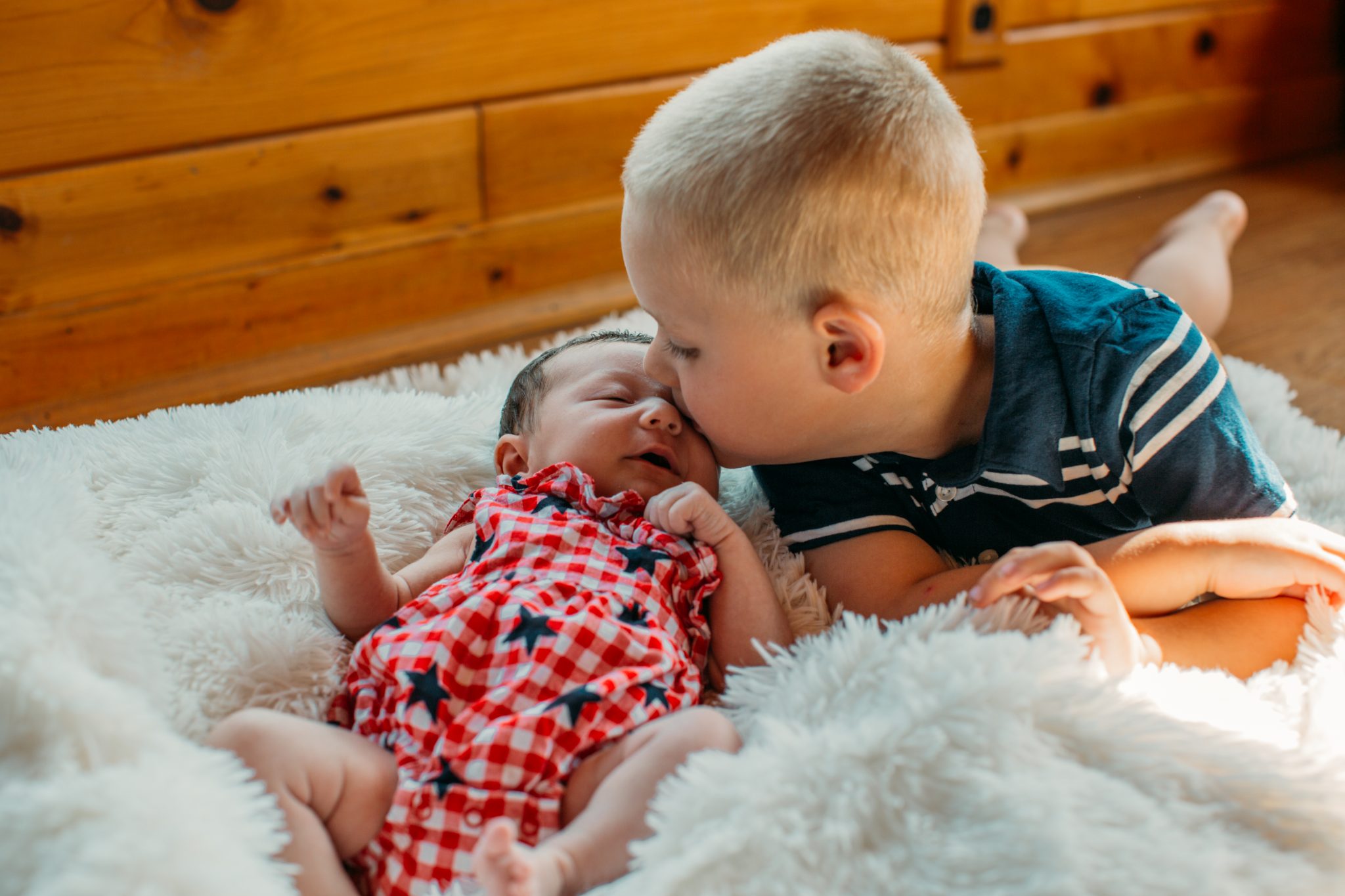 Henry kissing his littler sister Claire for her newborn photos