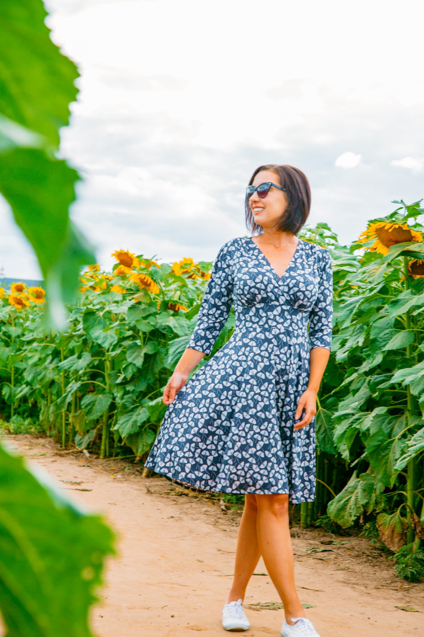 Wearing Karina Megan Dress in a sunflower field in Wisconsin