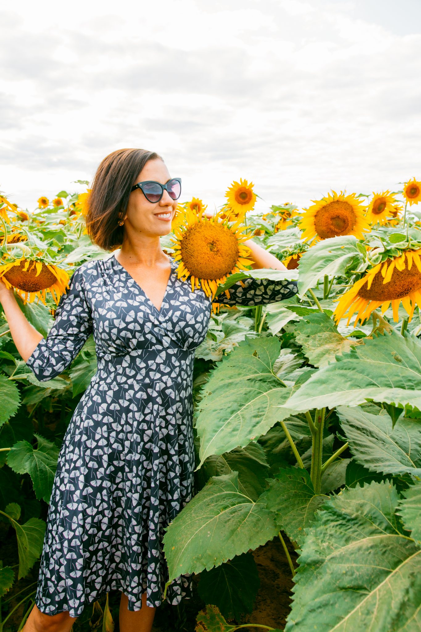 Wearing Karina Megan Dress in a sunflower field in Wisconsin