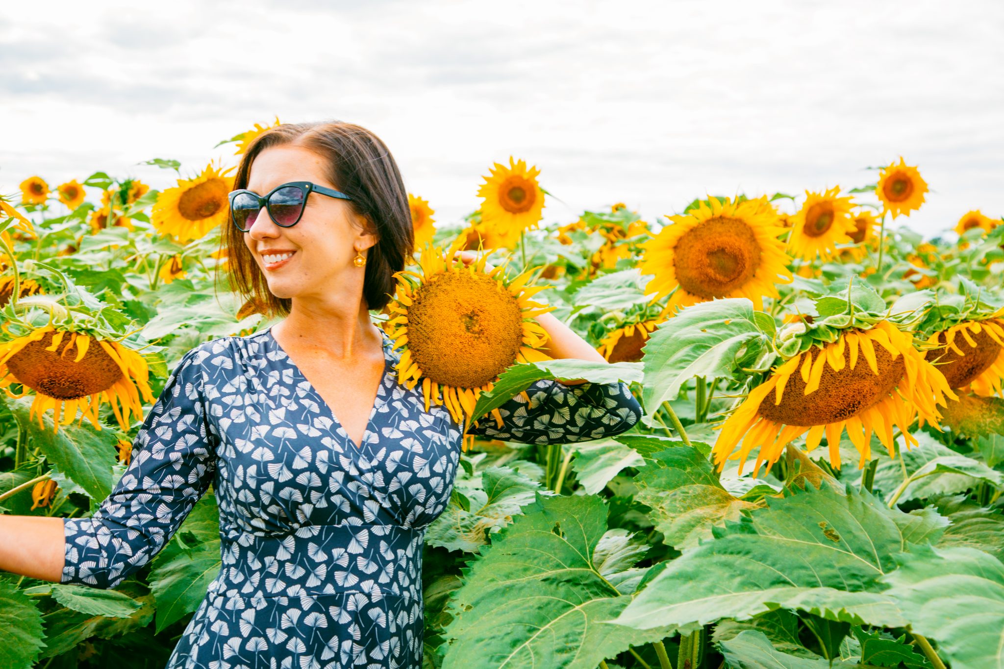 Wearing Karina Megan Dress in a sunflower field in Wisconsin