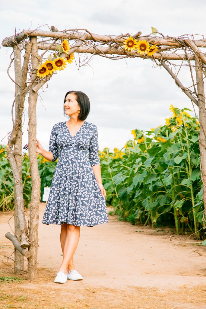 Wearing Karina Megan Dress in a sunflower field in Wisconsin