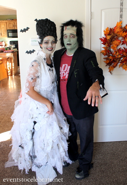 A man and woman pose together as Frankenstein and the Bride of Frankenstein.