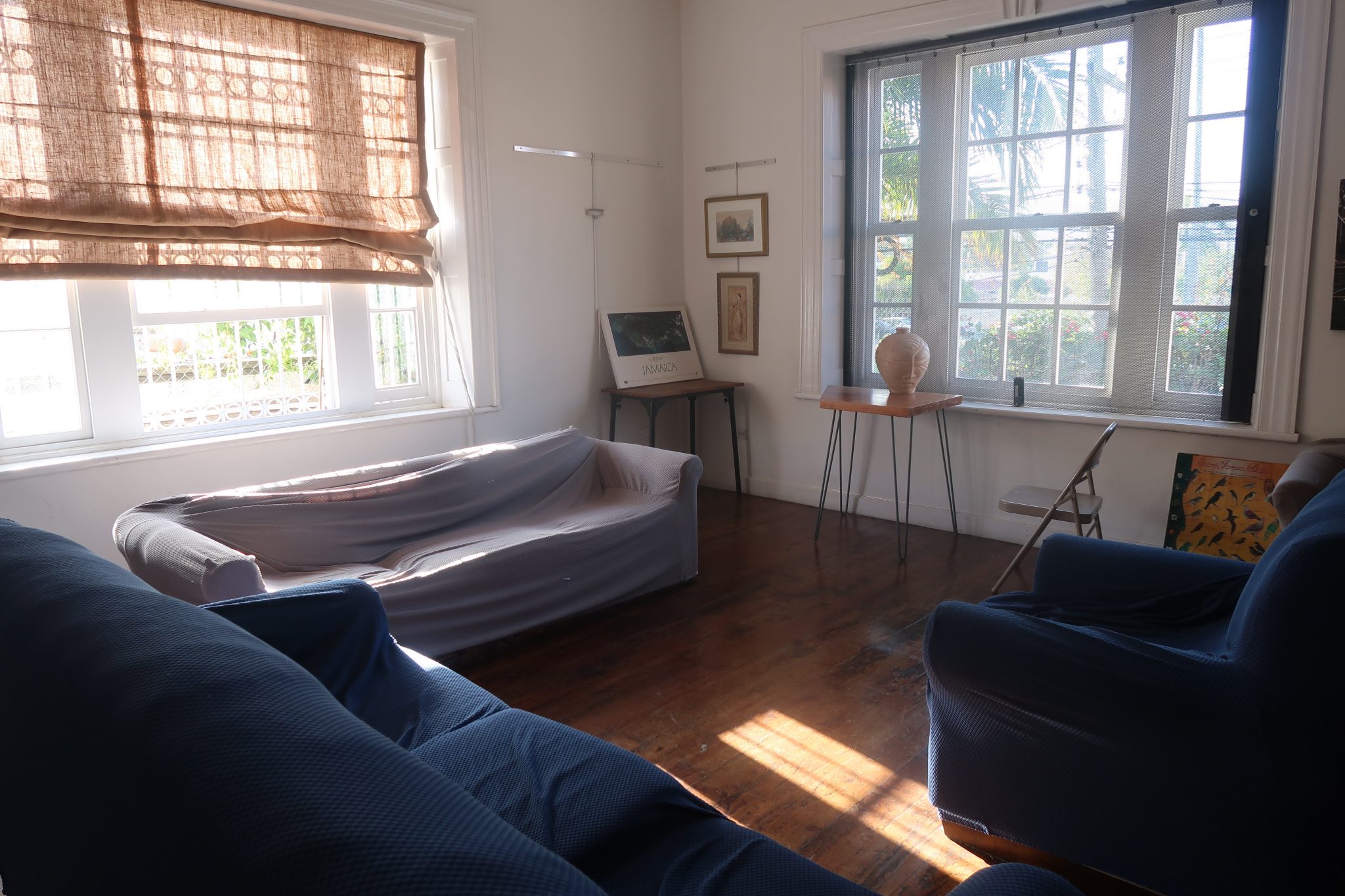 A community living room at Mobay Kotch hostel in Jamaica features two couches and an arm chair for guests to sit and relax in during their stay.