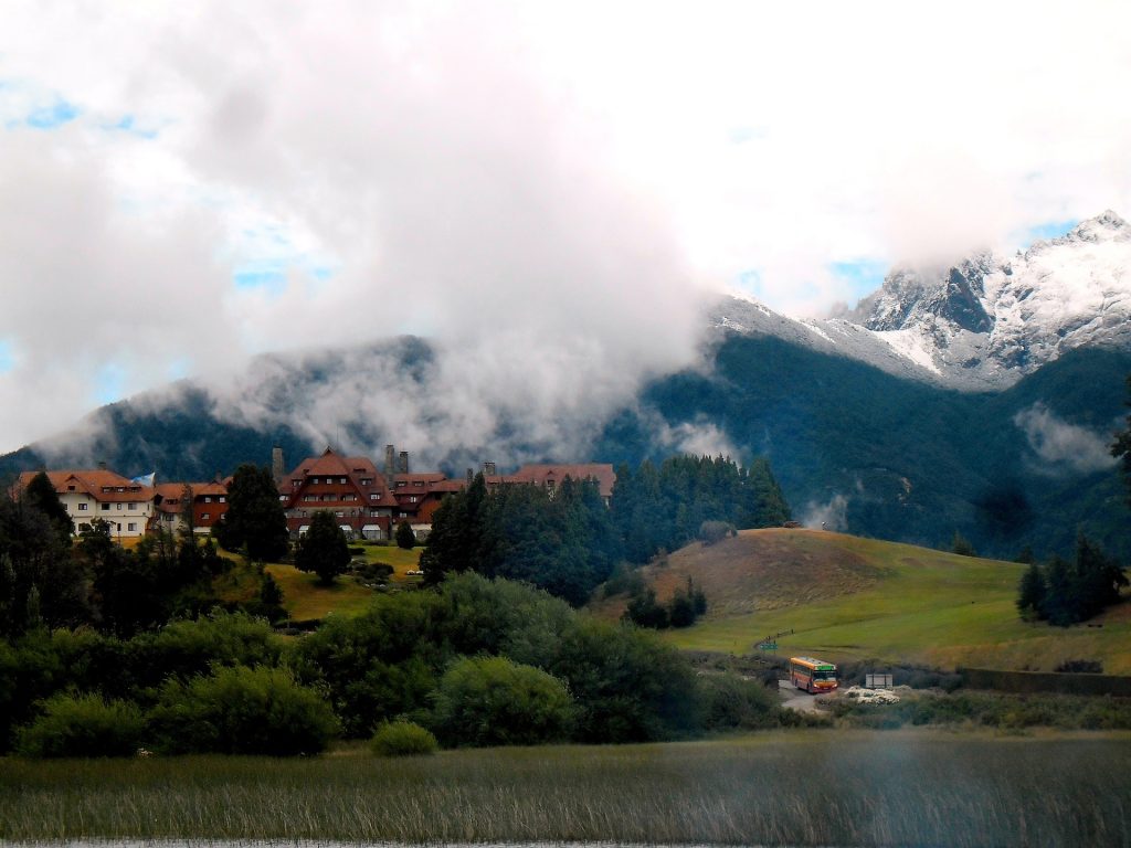 Low lying clouds floating across a picturesque view of houses in a distance in San Carlos de Bariloche, Argentina.