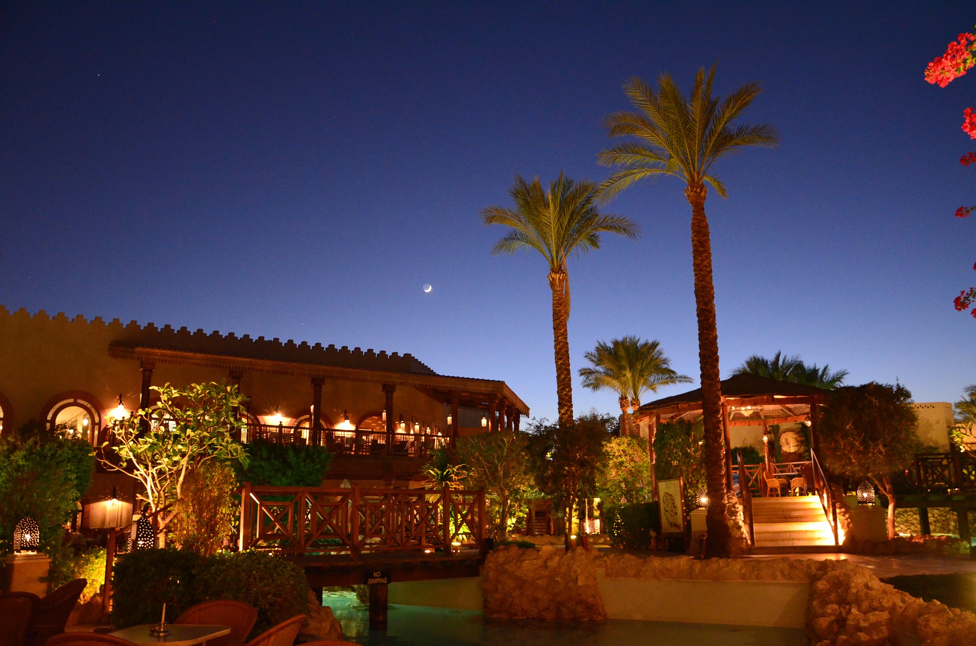 A night time image of a hotel in Sharm el-Sheikh with the moon visible in the sky. 