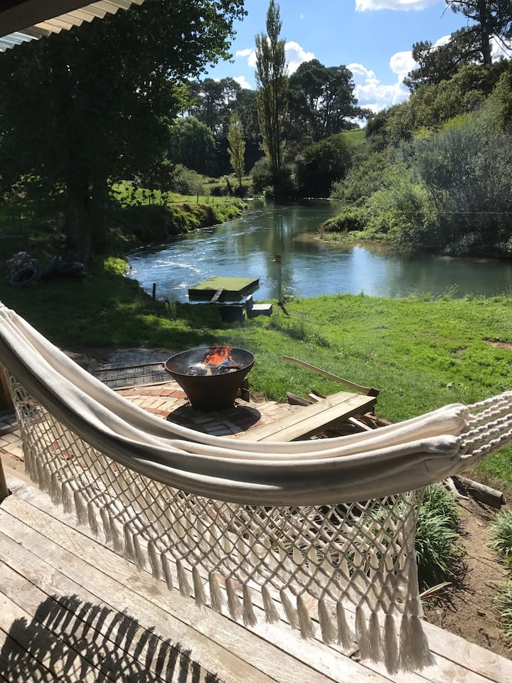 Te Waihou Riverside Retreat featuring a hammock, fire pit and beautiful river view