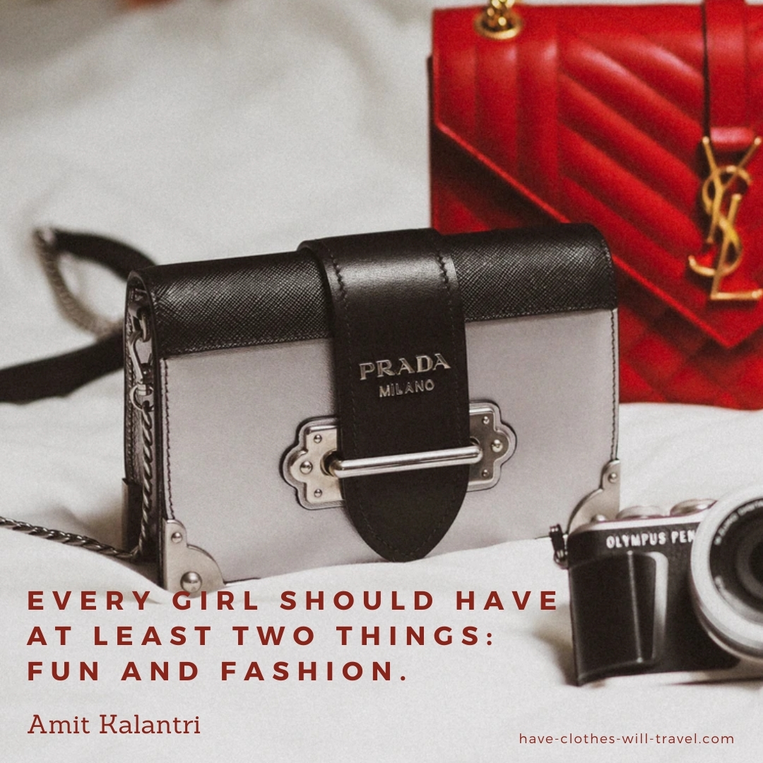 A close-up image of a black and gray Prada handbag with silver hardware. Text over the image reads, "Every girl should have at least two things, fun and fashion. ― Amit Kalantri, Wealth of Words"