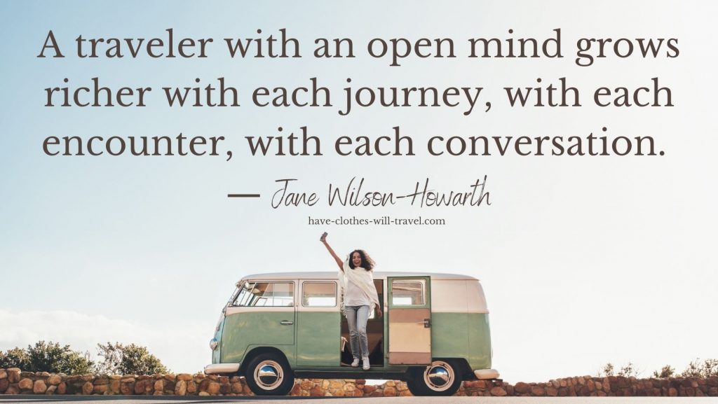 A woman steps out of a vintage VW van painted mind green and white, and waves her arms in the air. Text on the image reads, "A traveler with an open mind grows richer with each journey, with each encounter, with each conversation. - Jane Wilson-Howarth"