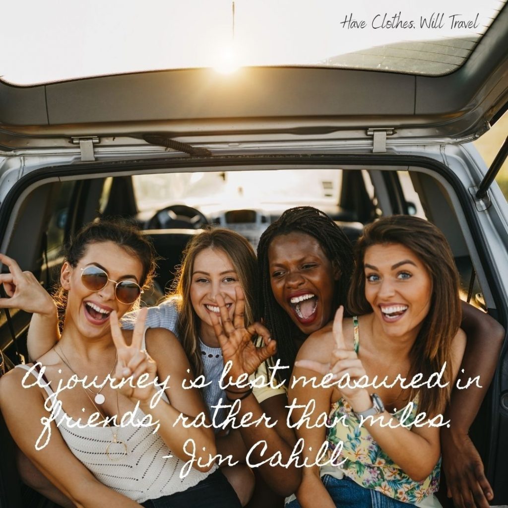 A group of four women sit in the back of a car. They're all smiling and holding up peace signs at the camera. White text over the image reads, "A journey is best measured in friends, rather than miles. - Jim Cahill"