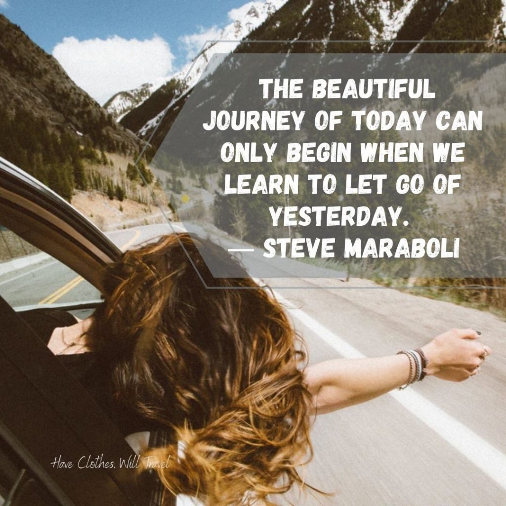 A woman in the passenger seat of a car leans her arm and head out of the window, her long brown hair blowing in the wind, driving down a mountain road. Text across the image says, "the beautiful journey of today can only begin when we learn to let go of yesterday. - Steve Maraboli