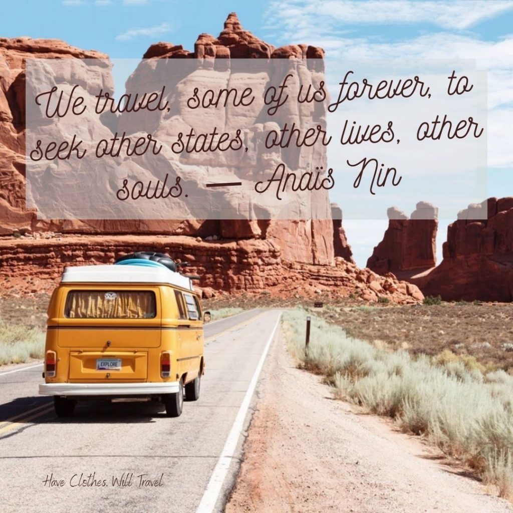 An old WV van painted mustard yellow drives down a road towards towering rock formations and cliffs. Text across the image reads, "We travel, some of us forever, to seek other states, other lives, other souls. - Anais Nin"