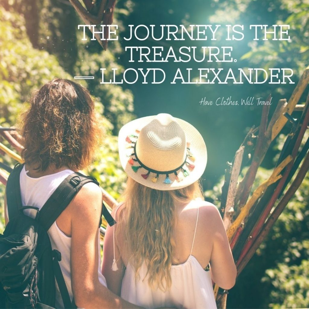 A couple stand with their backs to the camera, overlooking a scenic view on a hike. Text on the image reads, "The journey is the treasure. - Lloyd Alexander"
