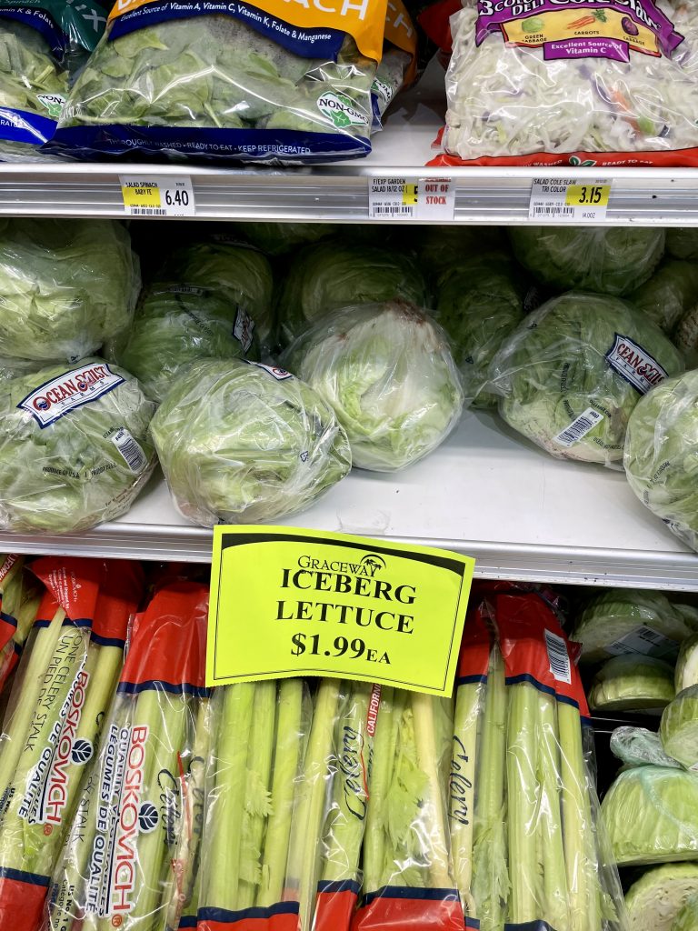 A grocery store shelf with iceberg lettuce in Turks and Caicos.