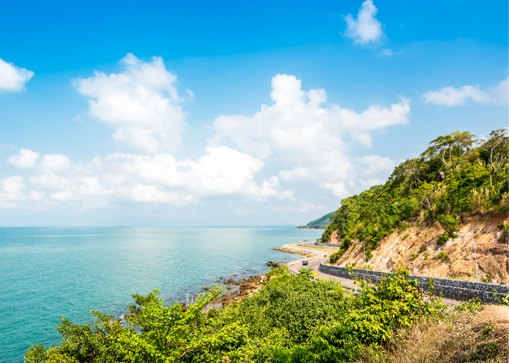 A road on a cliff overlooking the ocean.