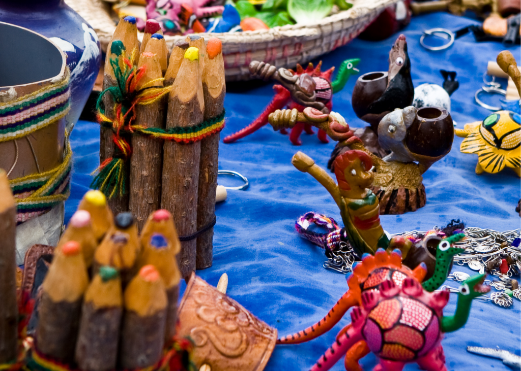 A table full of colorful items on a blue tablecloth at Alverna’s Craft Market.