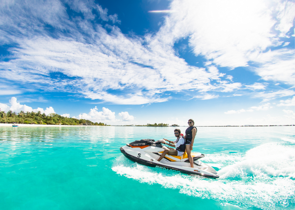 Two people riding a jet ski on the water on West Harbour Bluff.