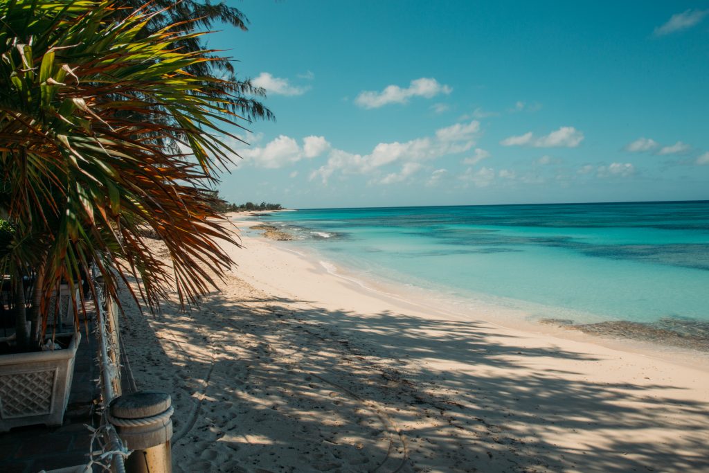 Pillowy beach in Grand Turk with palm trees and turquoise water.