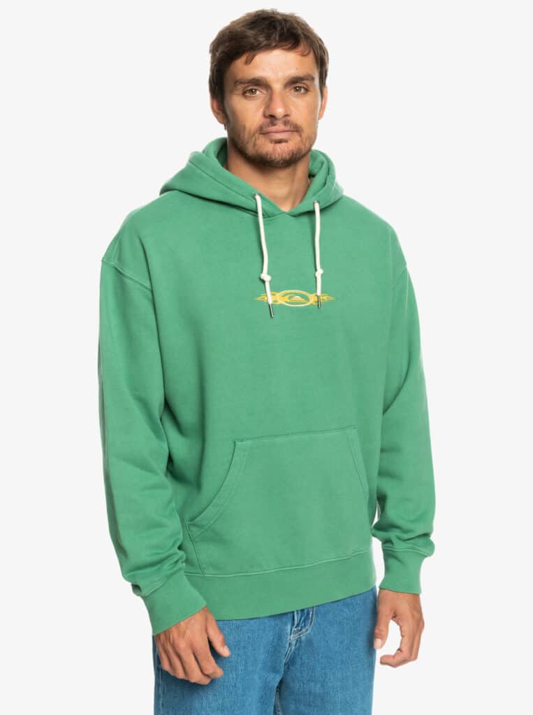 Young man wears a green hoodie from Quicksilver called the Saturn hoodie
