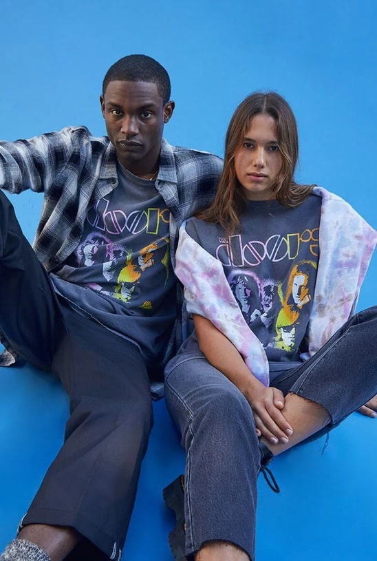 A young man and young woman wearing a The Doors Band Oversized T-Shirt from Pacsun with jeans
