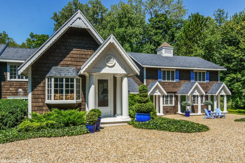 A home with blue shutters and a driveway - wide angle view of a 7-bedroom Luxury Designer Home Near Hiking Trails.