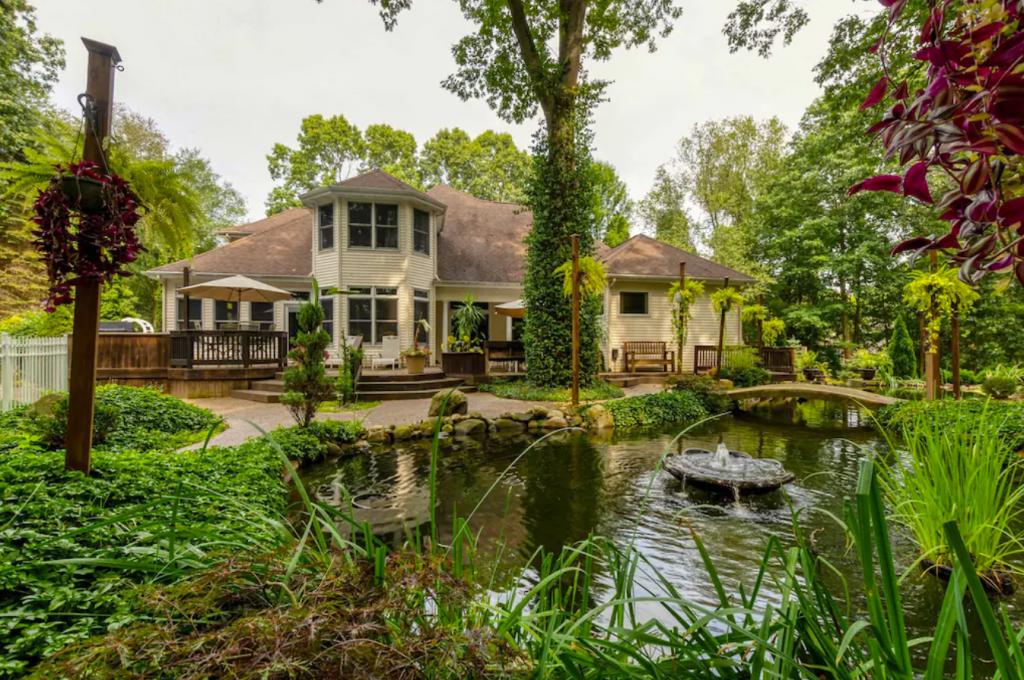 A house with a pond in the back yard.