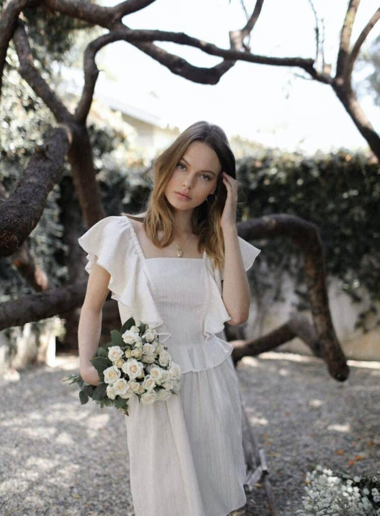 Model Wearing a  Cottagecore Bellevue The Label  Bianca Fit Flare Dress in Cream from Verishop