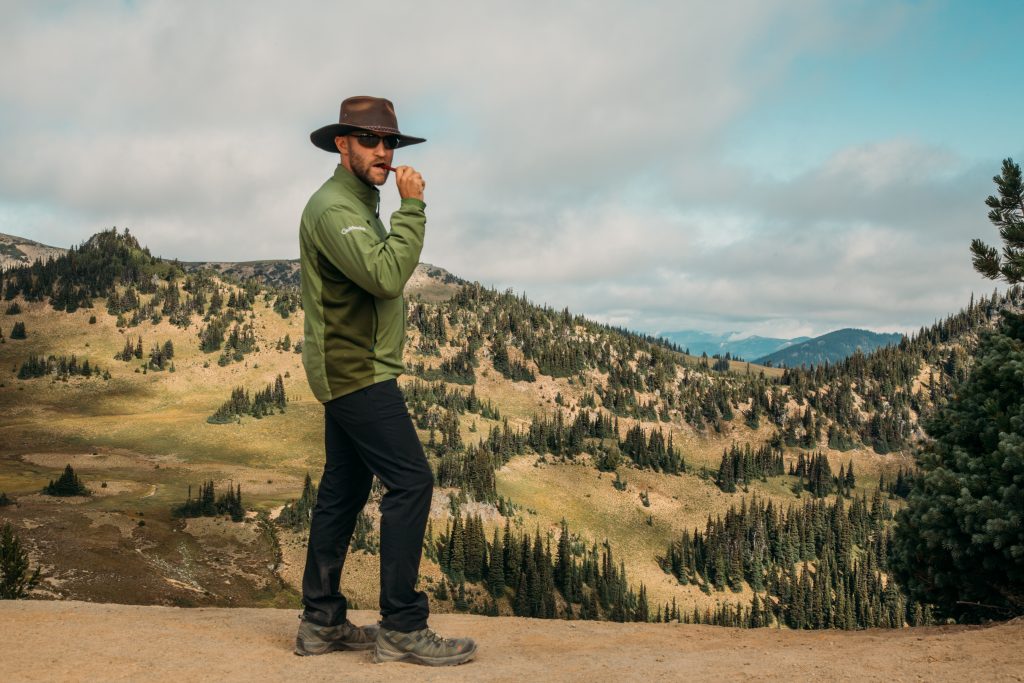 Zac wearing the NxTSTOP Men's Airway Travel Pant Powered by Heiq Hyprotecht in Washington State while hiking.