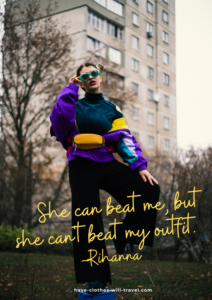 A woman stands outside in a park. She's wearing 90s-style athletic jacket, a yellow fanny pack, and black pats. Yellow text over the image reads, "She can beat me, but she cannot beat my outfit. – Rihanna"
