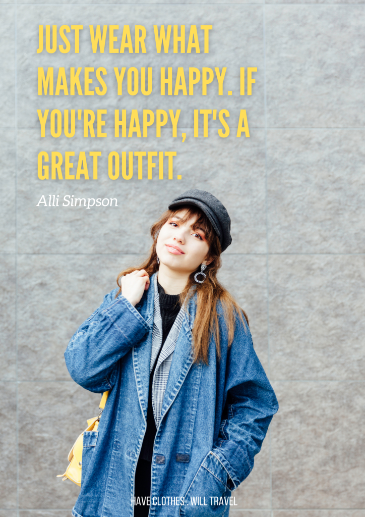 A young woman with long brown hair is wearing a long denim jacket and gray pageboy hat. She is standing in front of a gray stone wall. Yellow text on the image reads "Just wear what makes you happy. If you're happy, it's a great outfit. - Alli Simpson