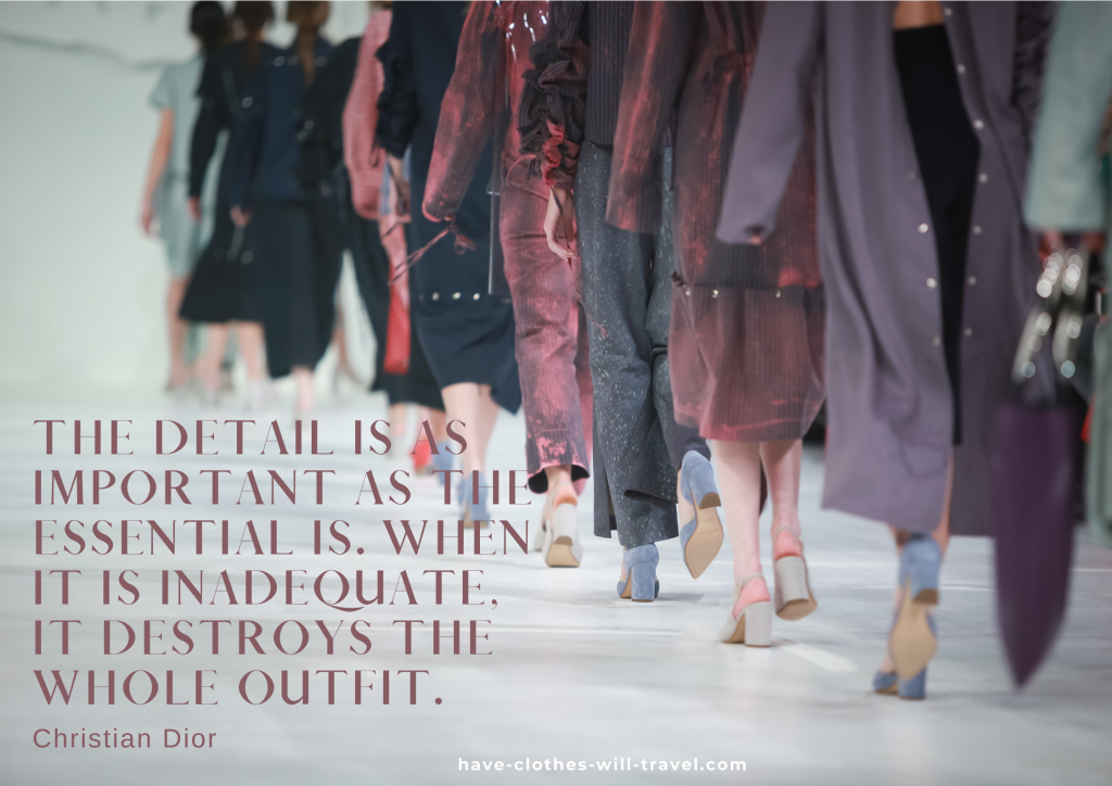 A line of models walk a runway during a fashion show, wearing long coats, pants, and heels. Text overlayed on the image says "The detail is as important as the essential is. When it is inadequate, it destroys the whole outfit. - Christian Dior"