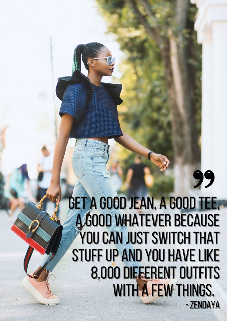 A young black woman walks across the street wearing a casual outfit of jeans, a navy blue cropped t-shirt, pink sneakers, and sunglasses. She's carrying a leather purse. Black text overlayed on the image reads, "Get a good jean, a good tee, a good whatever because you can just switch that stuff up and you have like 8,000 different outfits with a few things. – Zendaya"