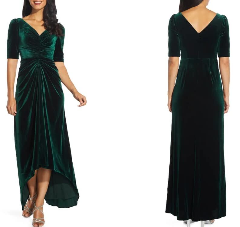 An image features a white dark-haired female model wearing a long emerald green velvet dress. There is a front and back image of the dress, showing the high-low them in front and back.