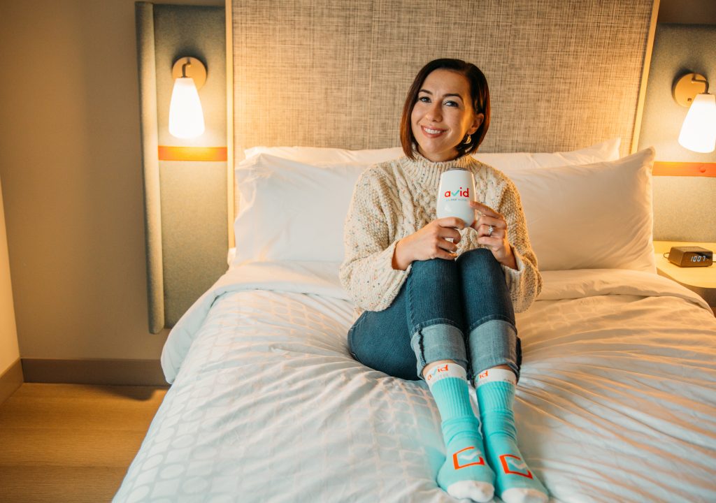 A woman wearing a colorful dots high neck chunky knit sweater from Chicwish.