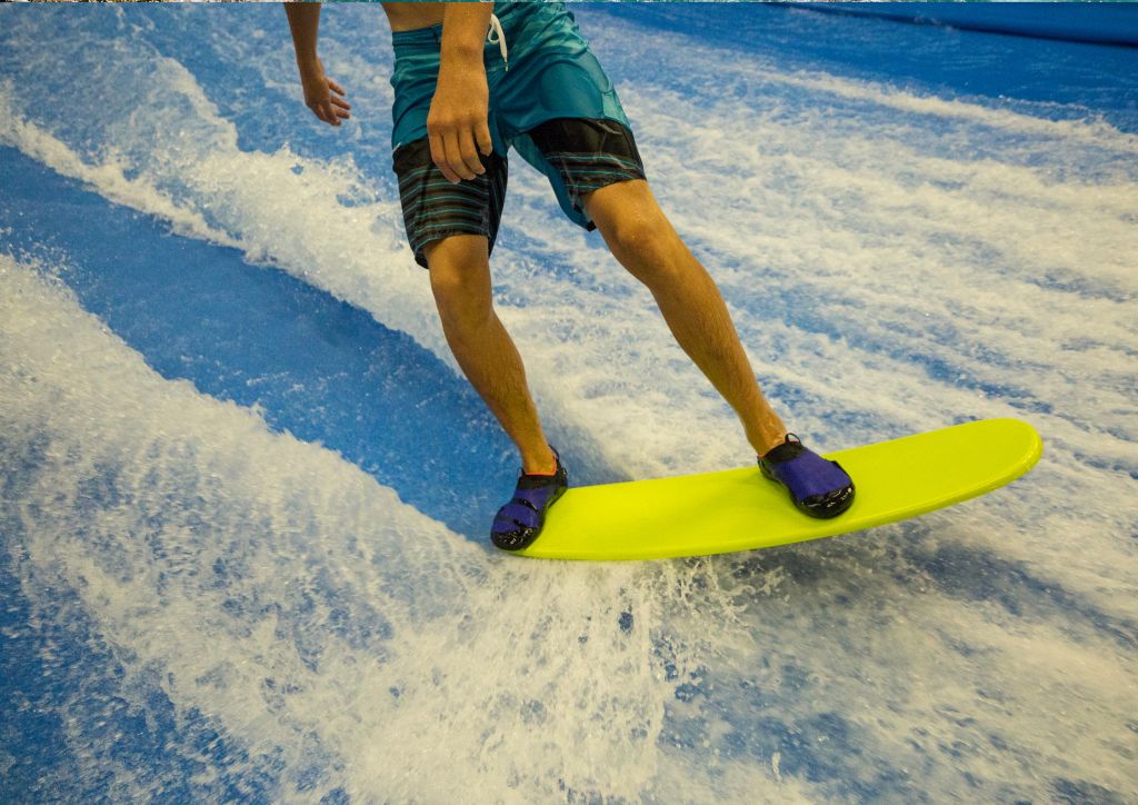 A man riding a surfboard in at FlowRider, Grand Turk.