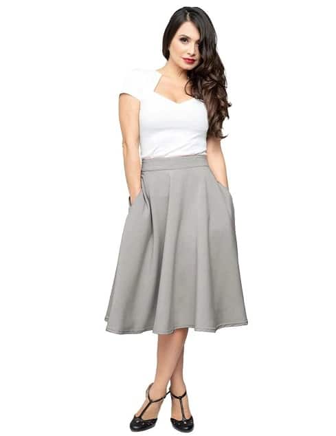 A woman models a white top and Pocket High Waist Thrills Skirt in Heather Grey by steady clothing
