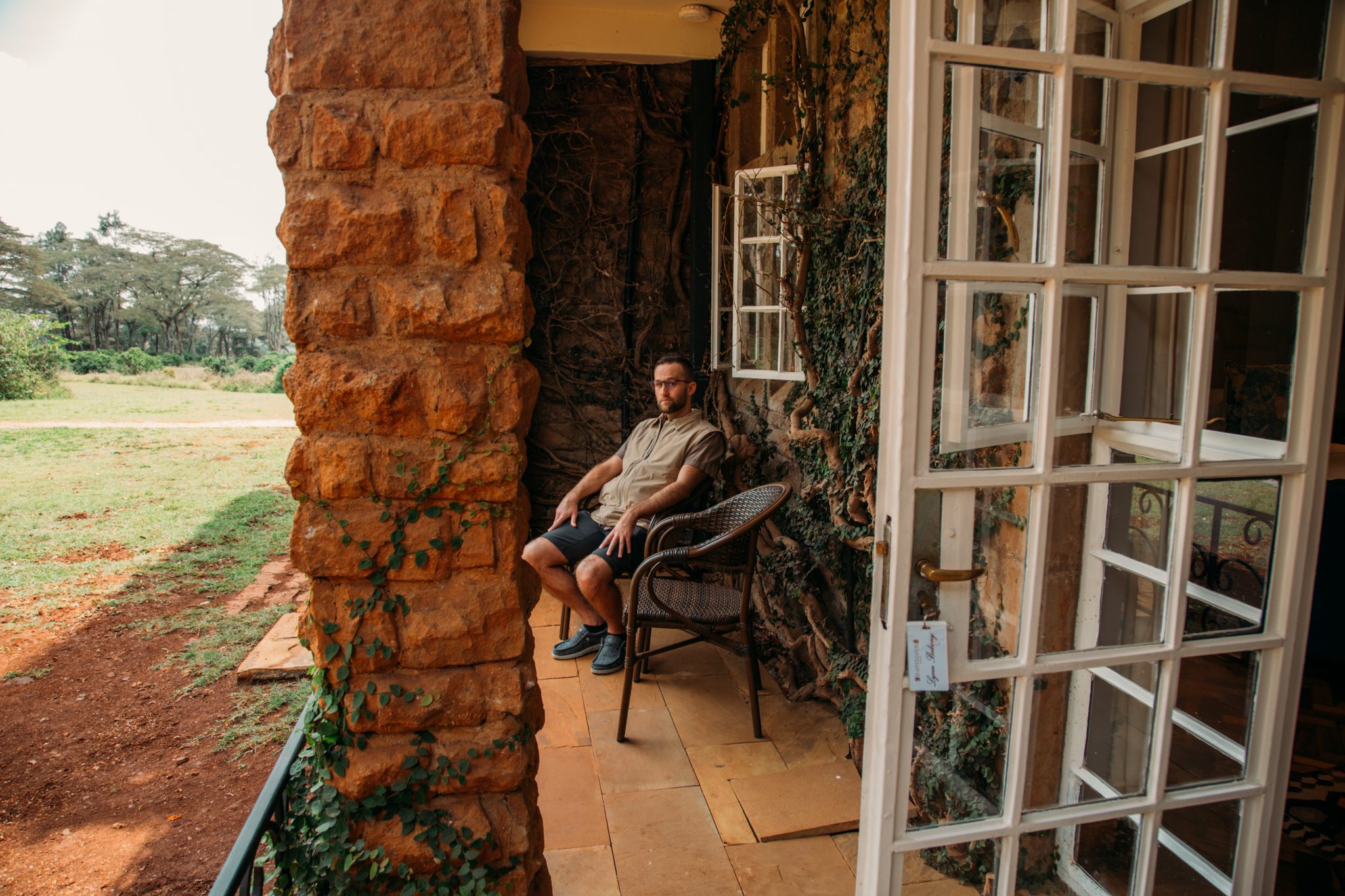 A man sitting on a chair on the porch in Lynne room, Giraffe Manor.