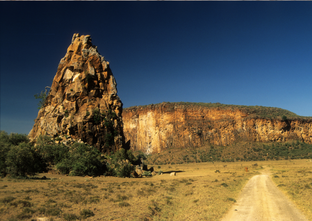 A dirt road in the middle of a field in Hell’s Gate National Park, Kenya.