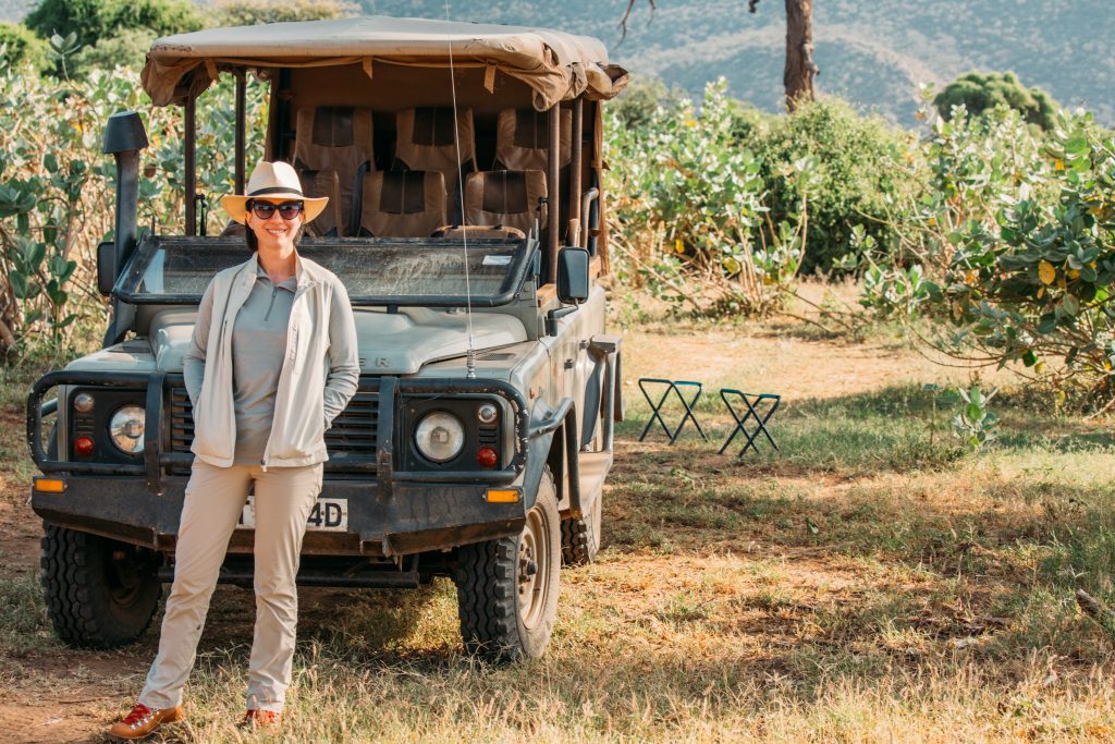 Saruni Samburu safari wearing my Scottevest travel vest standing by a jeep