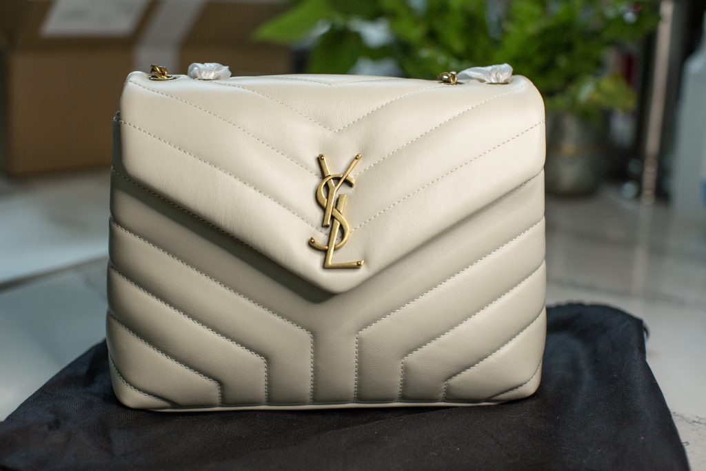 The 2023 New YSL Saint Laurent New JUNE Quilted Sheepskin Box Bag features  a front flip, shaped barrel design, and extremely compl… in 2023