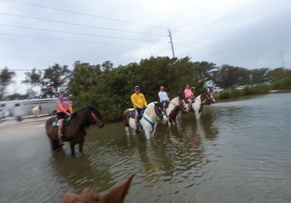 Riding our horses on the beach, despite the incoming rain.