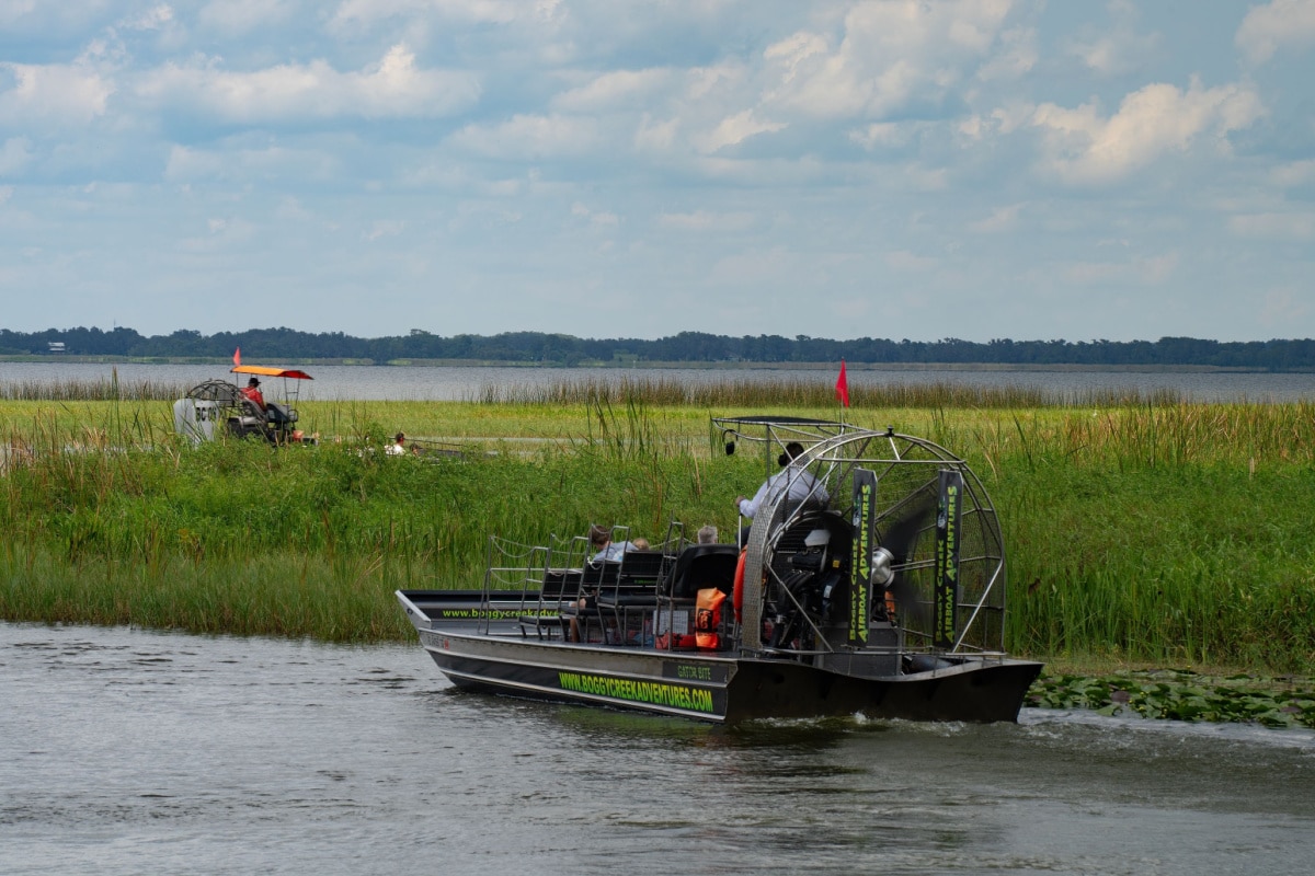 Orlando, USA - July 28th, 2023: Tourists on an airboat ride in Boggy creek in the Florida everglades.