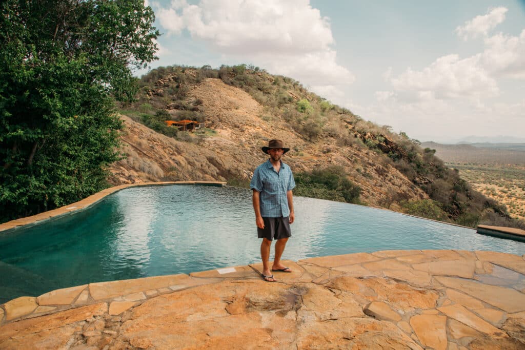 A man standing in front of a pool in Kenya.