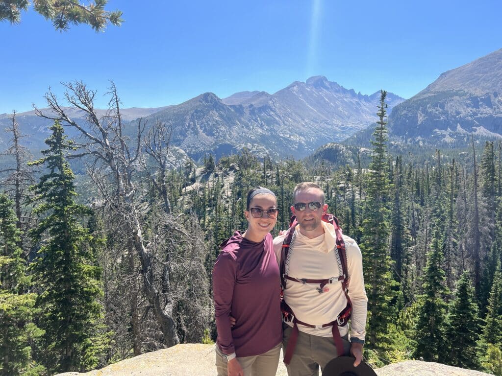Hiking in rocky mountain national park wearing or moisture wicking travel clothes and backpacks