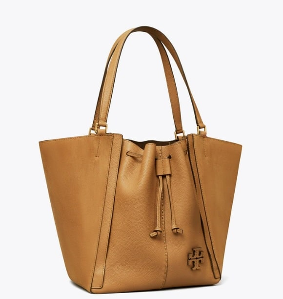 A caramel-colored leather oversized tory Burch tote bag pictured on a white background.