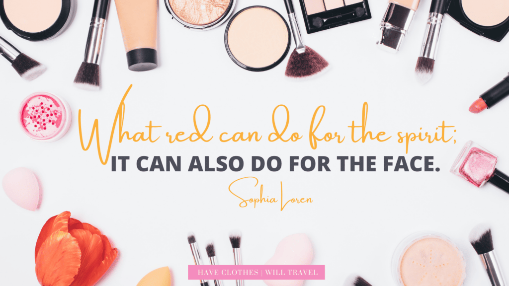 A flatlay image of makeup items around a center block of text that says, "What red can do for the spirit, it can also do for the face. - Sophia Loren"