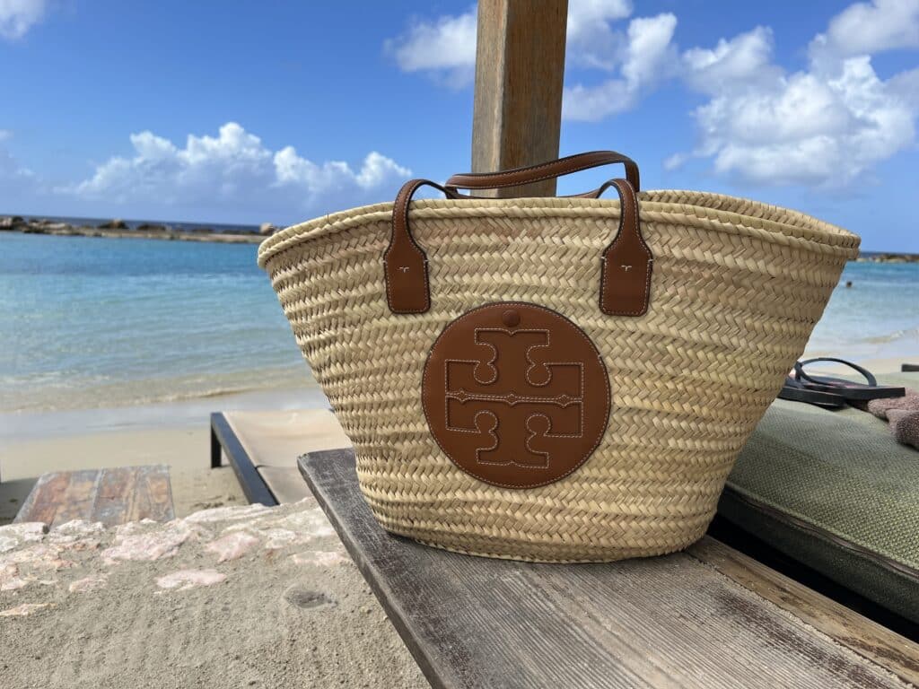 Tory Burch ella woven beach bag on the beach in Curacao