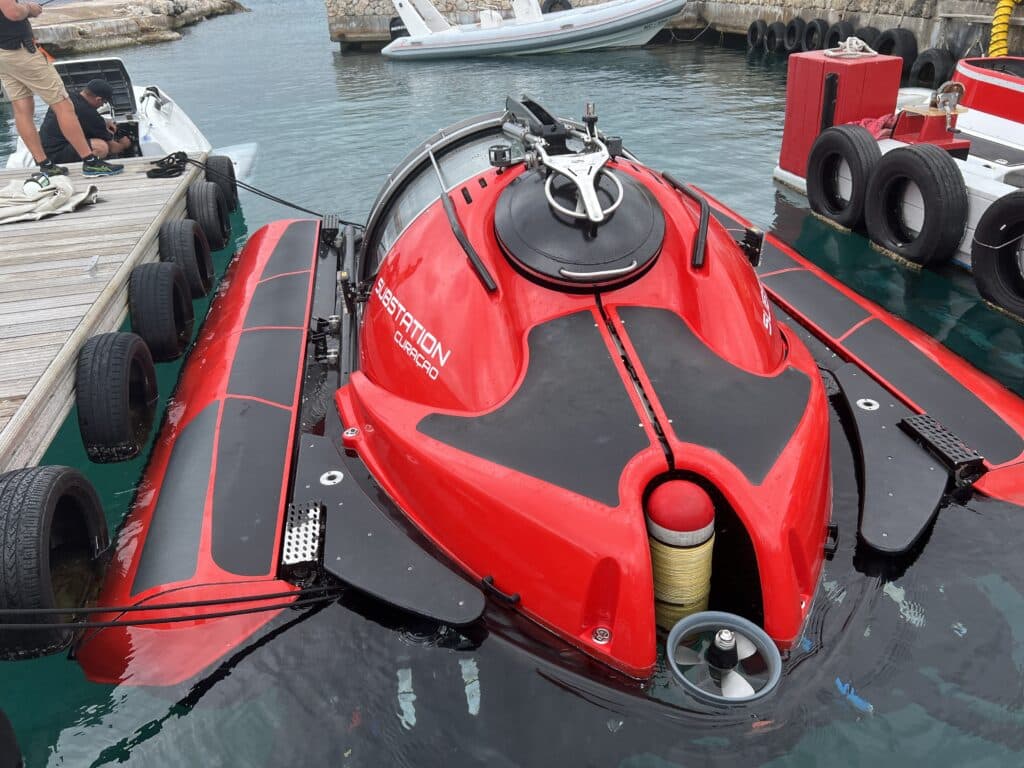 A red and black jet ski is docked at a dock.