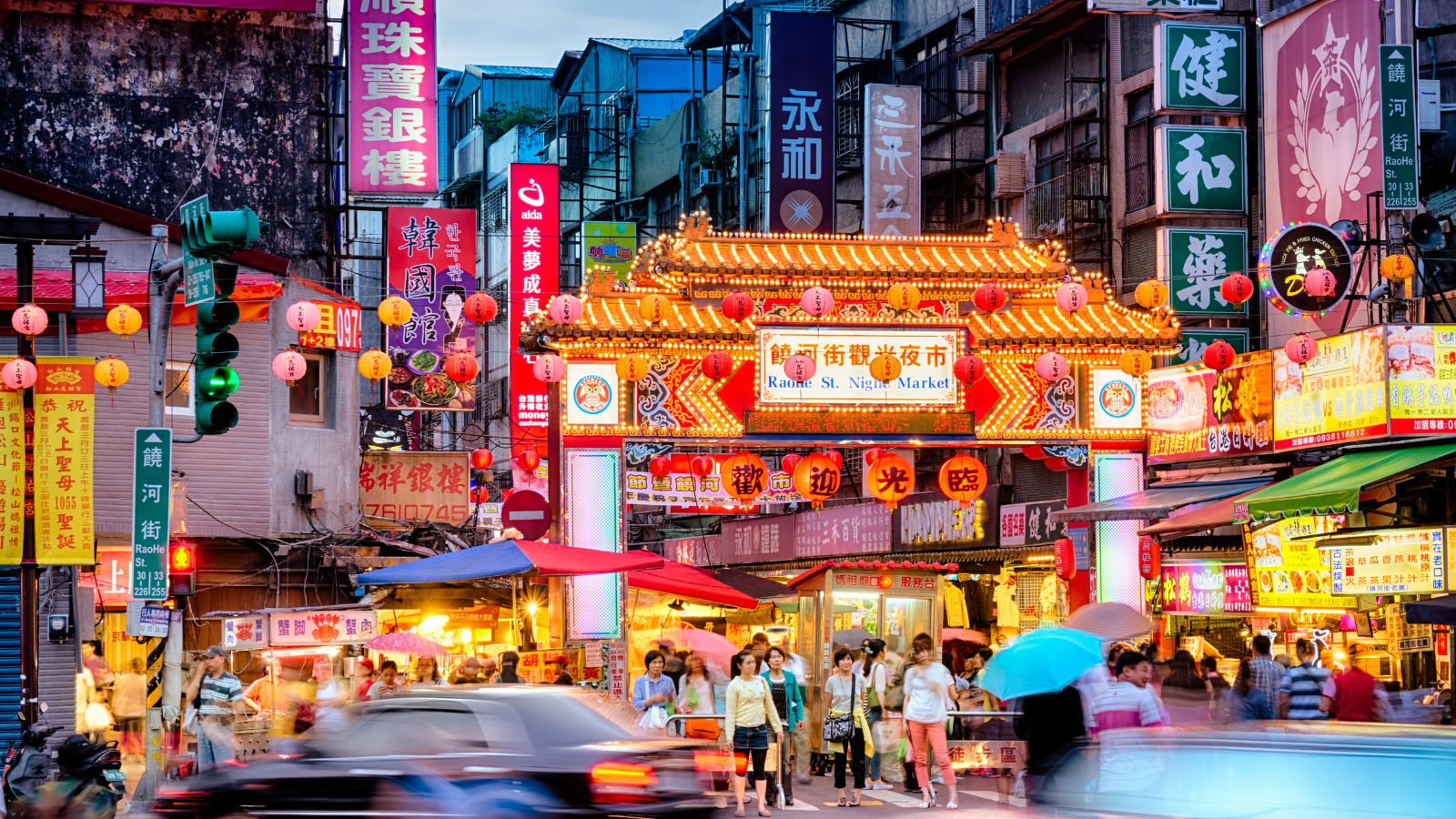 The busy, bright Raohe Street Night Market in Taipei, Taiwan features hundreds of stores, bright lights and traditional decorations, and more for tourists and locals.