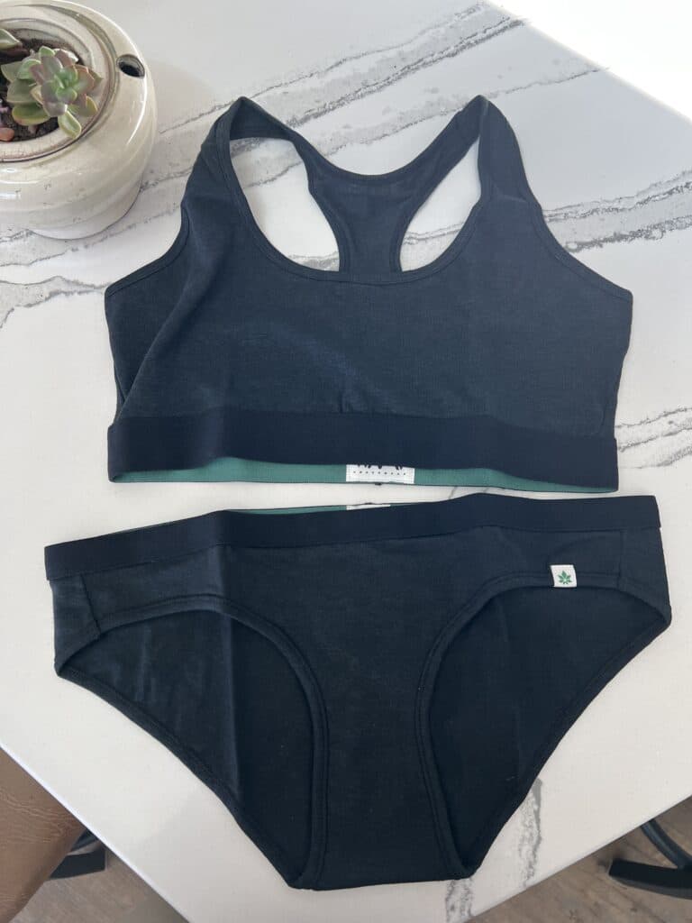 A navy blue sports bralette and underwear set from the sustainable clothing brand Wama.