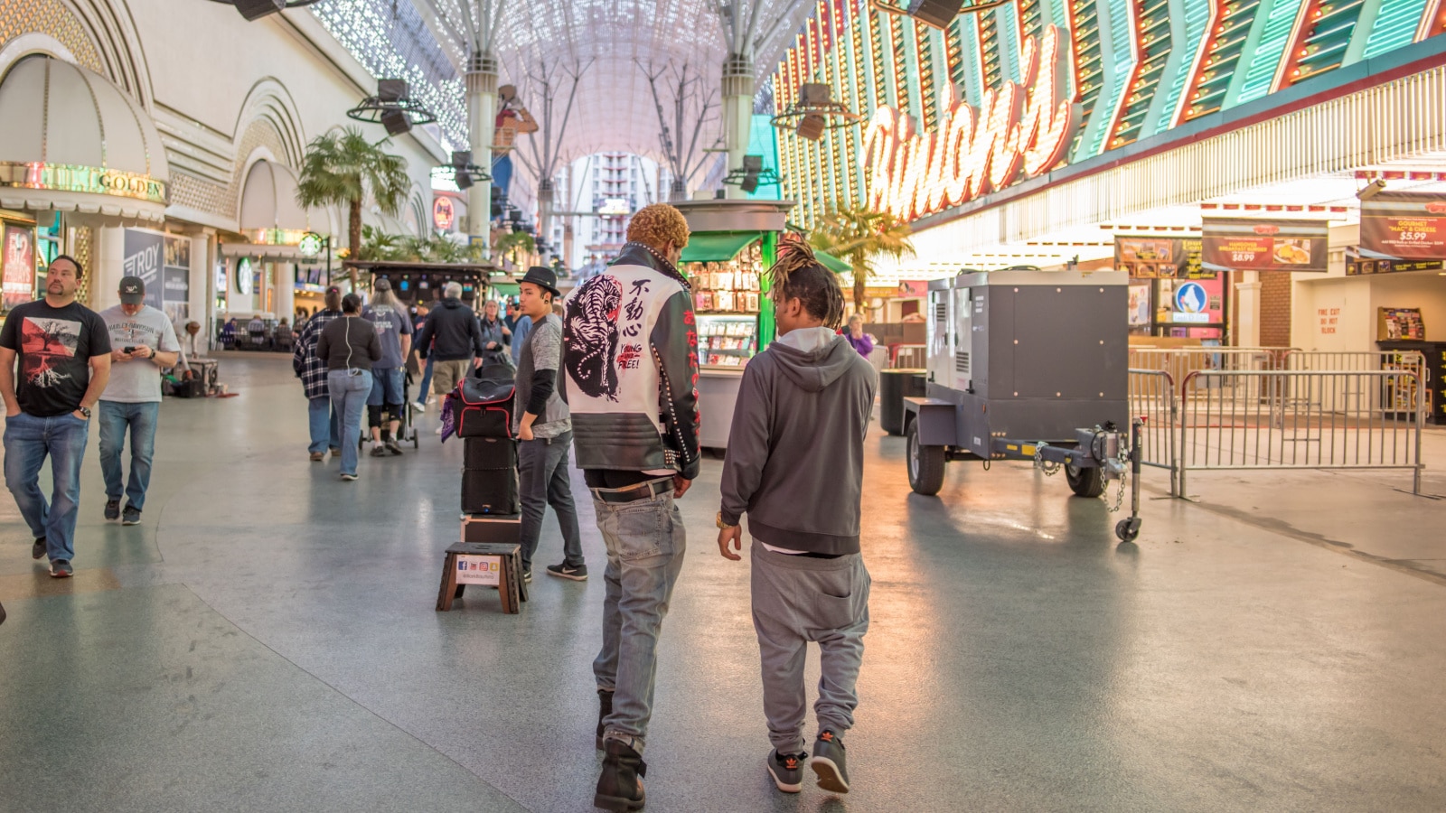 Las Vegas, NV / USA - March 6, 2018: Very stylish young men wearing trendy clothing walk along Fremont Street Experience, downtown Las Vegas.